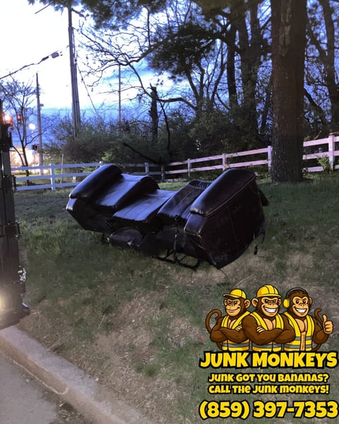 Three blue and black recliners on grass near wooden fence with Junk Monkeys logo and phone number overlay