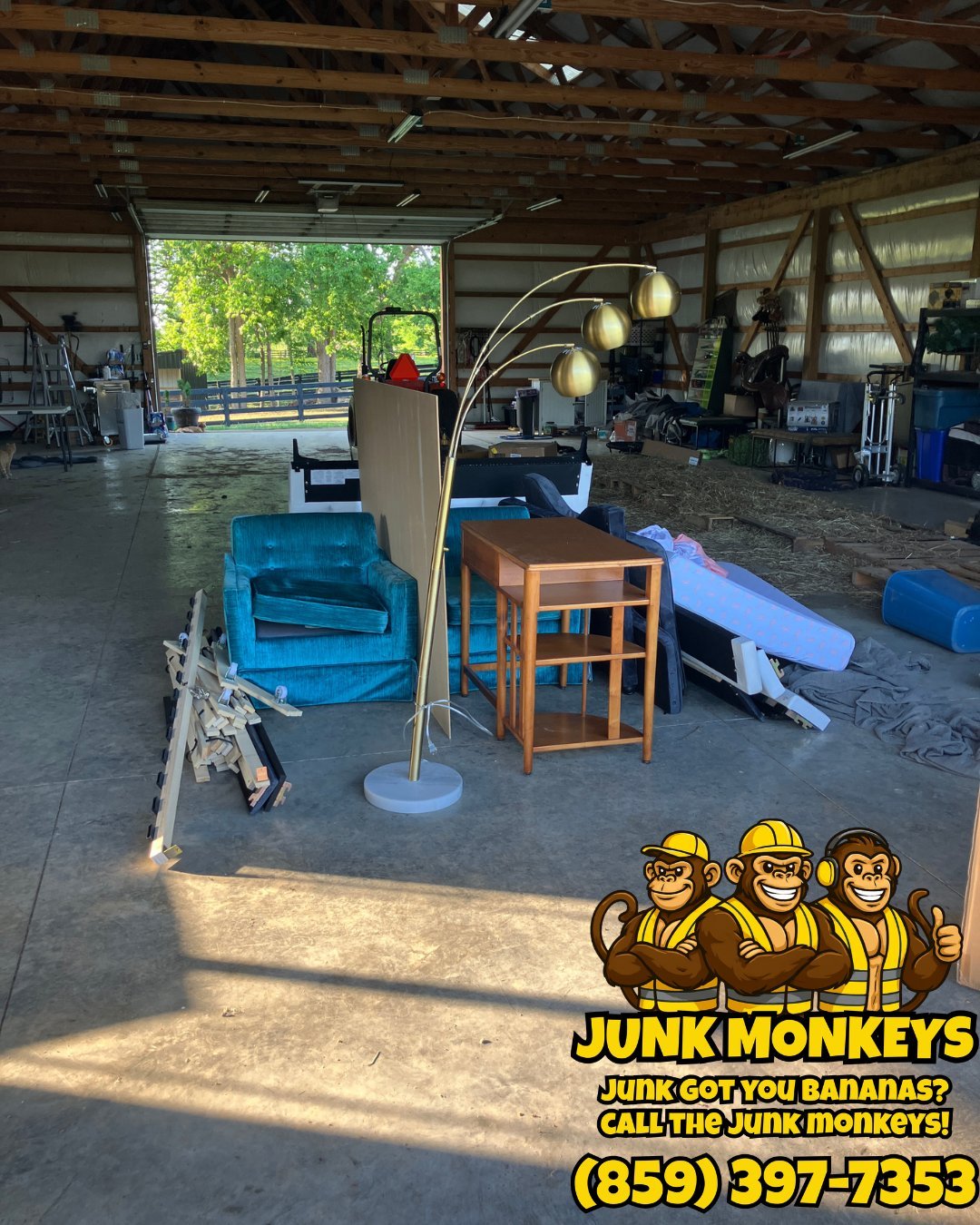 Junk removal warehouse with blue couch, wooden chair, arc lamp and other discarded furniture items, Junk Monkeys logo in corner